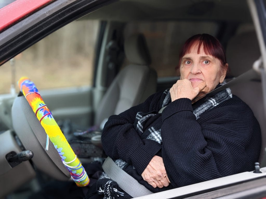 Linda sits in her car awaiting food at OneGenAway's disaster relief mobile food pantry distribution in Waverly, Tennessee.