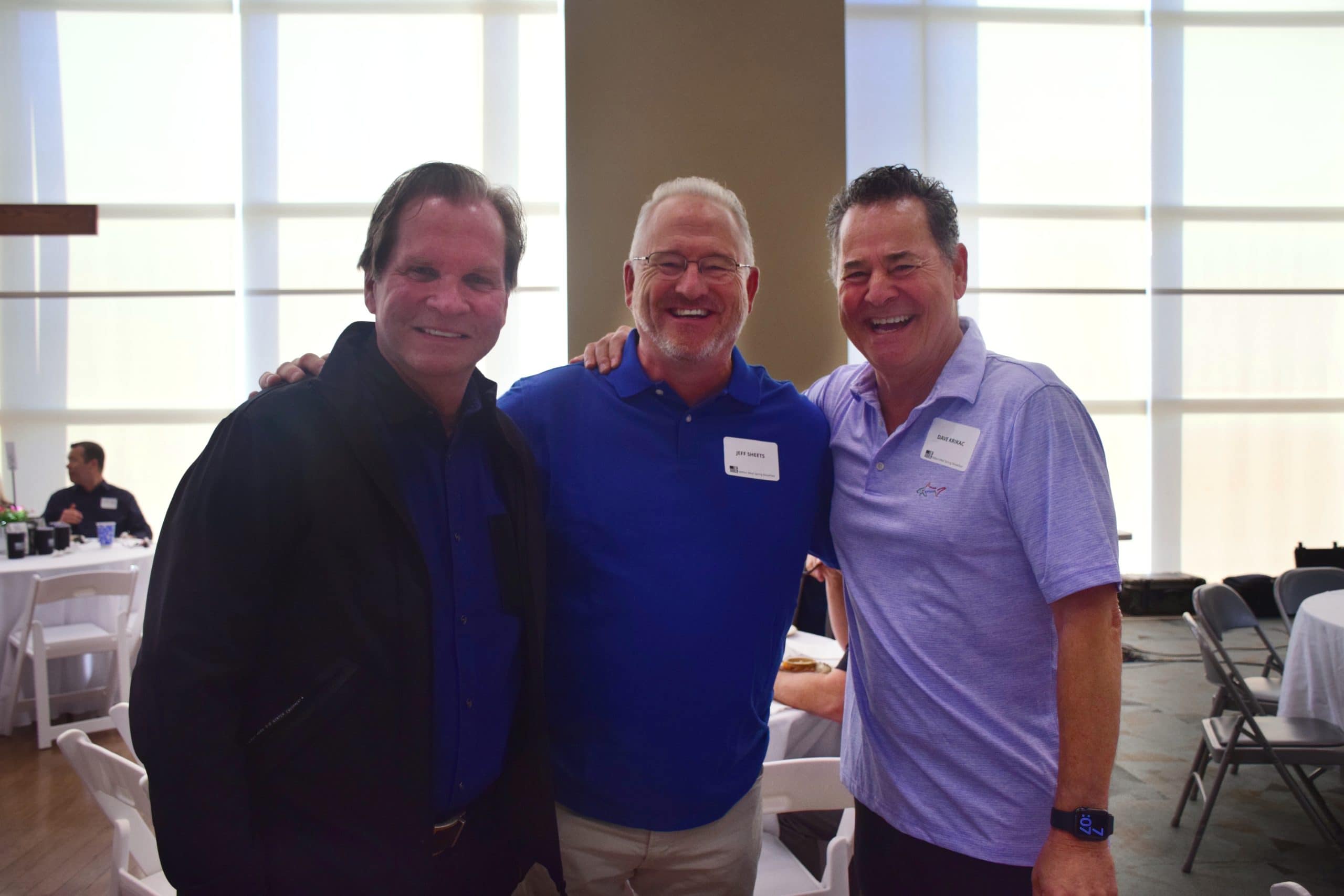 Three attendees smile for the camera at OneGenAway's 2022 Million Meal Spring Breakfast.